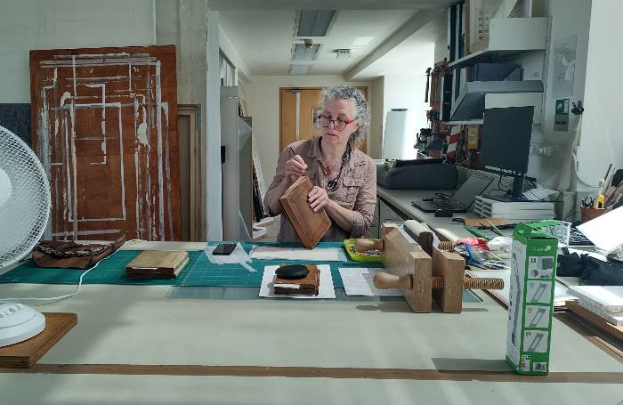 female conservationist working on RIBA book collection 700png